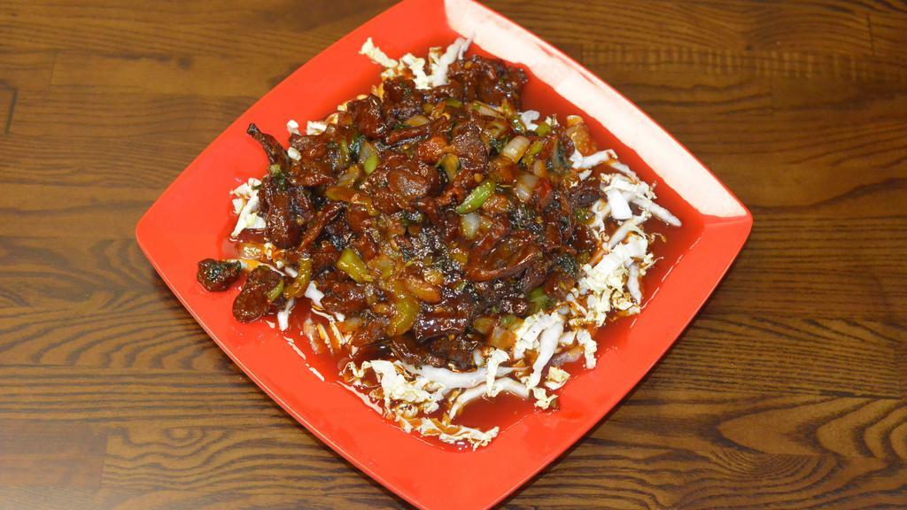 Moo Tod Rad Prig (Best Seller) · Crispy fried pork topped with onions, garlic, peppers and a chili sauce