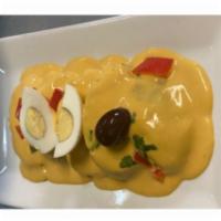 Papa A La Huancaina · Steamed potatoes with spicy creamy cheese sauce.