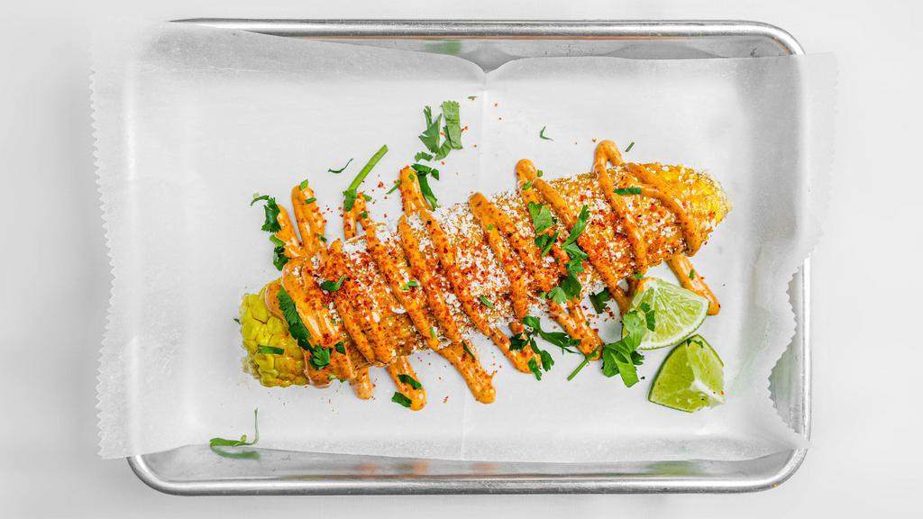 Elote  · Vegetarian. Corn on the, chipotle mayo, cotija cheese, Mexican chili powder .
