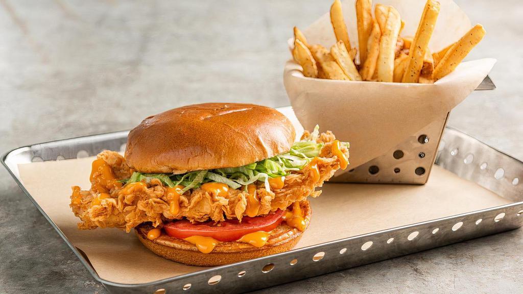 Big Mouth Crispy Chicken Sandwich · Hand-breaded crispy chicken, tomato and lettuce, topped with your choice of sauce on a brioche bun. Served with fries.