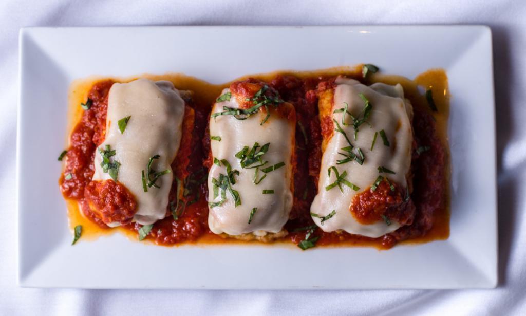 Eggplant Rollatini · Thinly sliced eggplant, lightly floured and breaded, stuffed with fresh ricotta and served with homemade sauce.