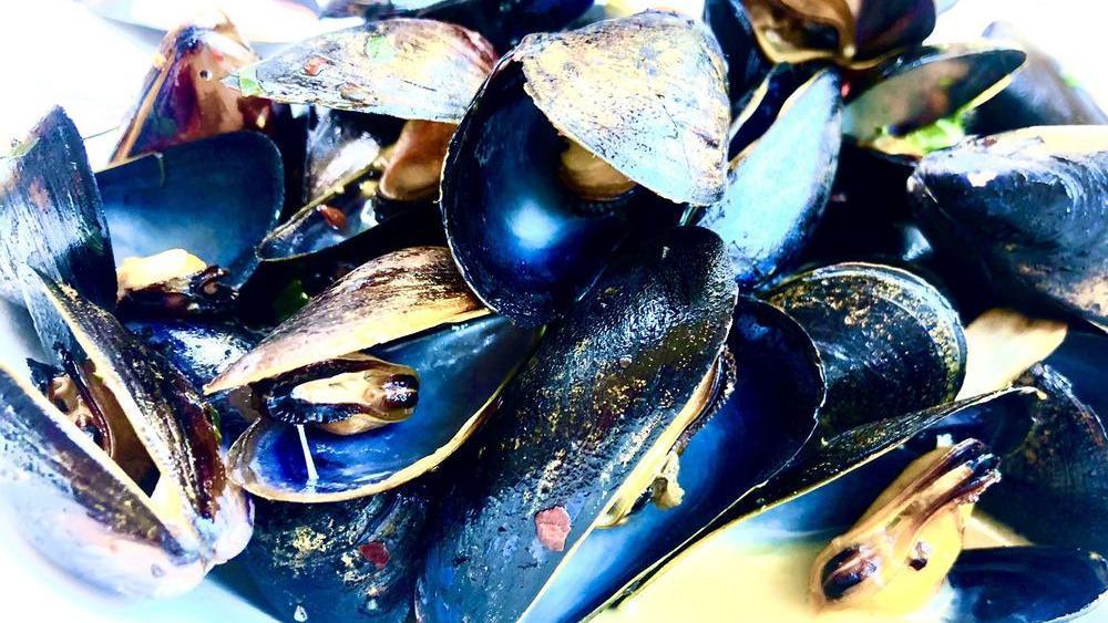 Mussels · Shallot, roasted tomatoes, basil chardonnay butter broth.