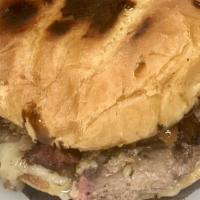 Brisket Cheesesteak Sandwich · Brisket topped with sautéed mushrooms and onions and American cheese on a toasted potato rol...