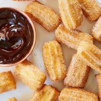 Churros Bites · Dusted with cinnamon sugar.
Served w/ chocolate & caramel dipping sauce!