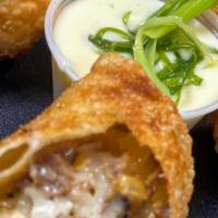 House Made Cheesesteak Egg Rolls · Shaved sirloin, sautéed onions, and cheese sauce.