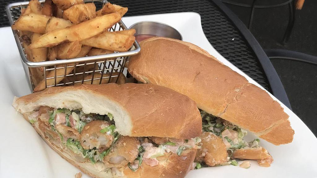 Shrimp Po'Boy · Bread fried shrimp, fried pickle chips, lettuce, tomato, tartar sauce on toasted roll.