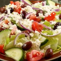 Greek Salad · Garden salad topped with feta grape leaves and pepperoncini.