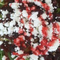 Stefanie’S Salad · Regular – fresh arugula, crushed walnuts, dried cranberries, feta with fat-free raspberry vi...