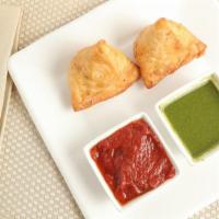 Samosa · Fried triangular pastry filled with spiced vegetables and served with green and red chutney.
