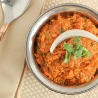Baingan Bhartha · Eggplant cooked with green peas, tomatoes, onions, and blend of Indian spices.