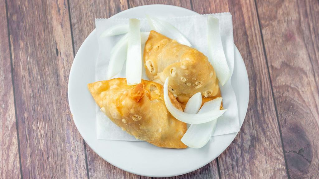 Samosa · Two pieces. Lamb, chicken, vegetable and coconut filled crispy and spiced patties. Two for serving.
