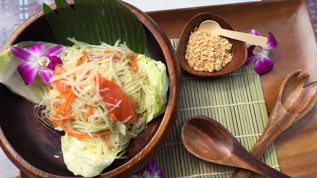 Papaya Salad · Spicy. Grated Fresh Green Papaya Tossed with Sugar Sweet Tomatoes in Spicy Garlic Lime Sauce & Crushed Peanuts.