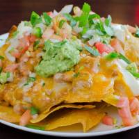 Nachos · Fresh corn chips, beans, melted Jack and Cheddar cheese, guacamole, pico de gallo, and sour ...