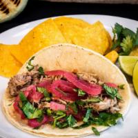 Roasted Pork Taco · Served with pickled onions and cilantro.