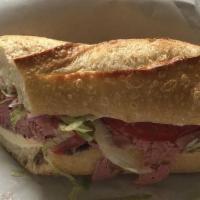 Main Sandwich · Roast beef, Cheddar, lettuce, tomato,  horseradish cream sauce on a Baguette. (about 12