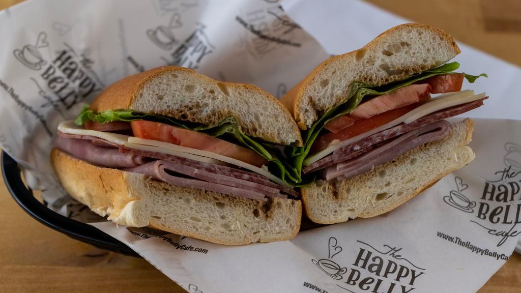 The Italian · Premium sliced ham and salami, provolone cheese, crisp lettuce and fresh tomatoes, reduced balsamic vinaigrette on French bread.