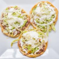 Regular Sope · 3 handmade corn tortillas topped with beans, lettuce, sour cream and cheese.