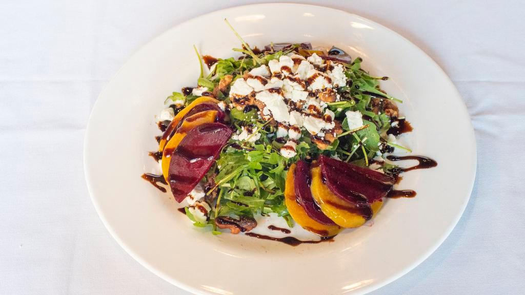 Beet Salad · Gluten-free. served with yellow and red beets, goat cheese and five-spiced honey glazed roasted walnuts with a side of baby arugula, topped with balsamic reduction.