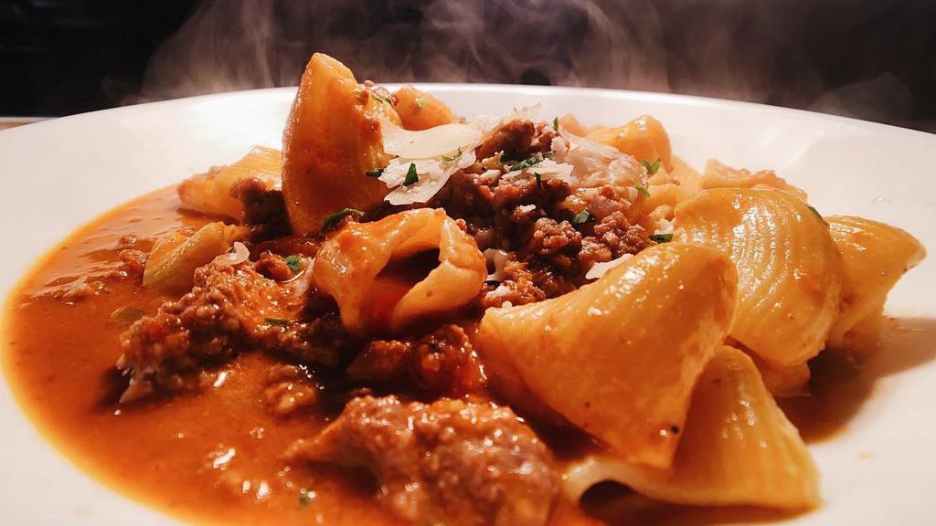 Rigatoni Bolognese · Represents a classic enjoyed by many for over 18 years. Traditional Italian meat sauce with shaved Parmesan.
