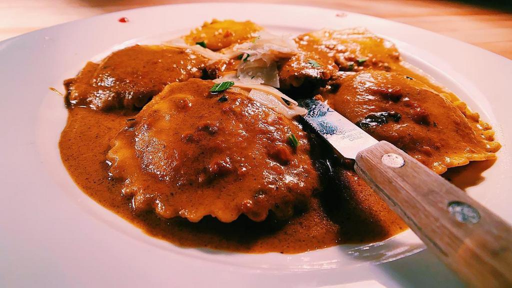 Lobster Ravioli · Represents a classic enjoyed by many for over 18 years. Has Nuts (EVOO) extra virgin. Served with tomato, basil and pesto cream sauce.