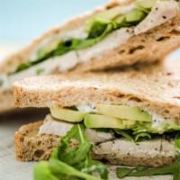 Turkey Avocado Sandwich · Tasty sandwich made with Oven Gold Turkey, Mix Greens, Tomatoes, Chipotle Mayo.