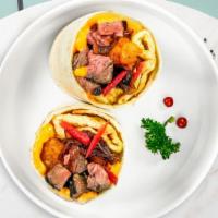 Past Is Pastrami Breakfast Burrito · Pastrami, eggs, cheddar cheese, tomatoes and onions wrapped in a flour tortilla.