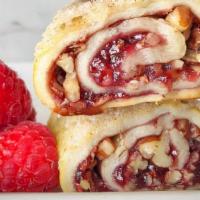 Raspberry Rugelach · The flaky and buttery hand-rolled dough is filled with raspberry preserve and pecans, making...