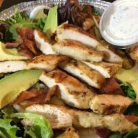 Chicken Cobb Salad · Chicken, mixed greens, avocado, crispy bacon, blue cheese and a hard-boiled egg. Tossed in o...