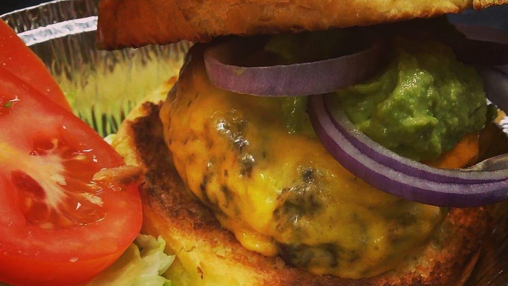 9 Oz Cheeseburger · Your choice of cheese. 100% Angus beef served on a toasted brioche bun. Includes lettuce, tomatoes, pickles and our special spread.