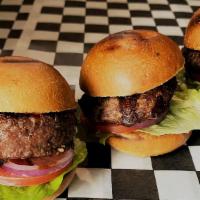 Beef Sliders · Three pieces of burger sliders served with lettuce, tomato, pickles.