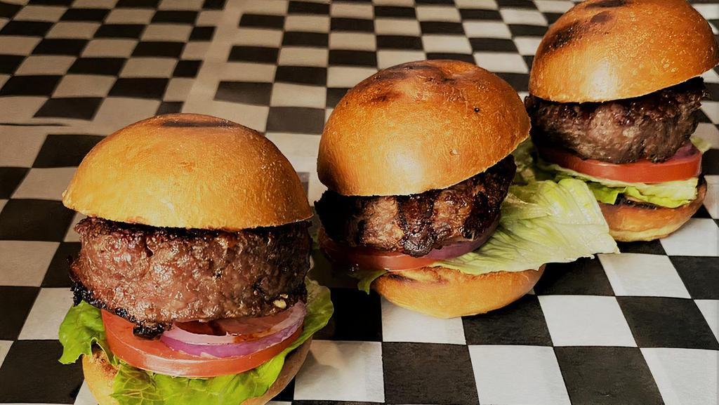 Beef Sliders · Three pieces of burger sliders served with lettuce, tomato, pickles.