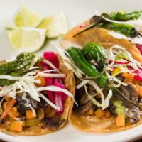 Market Vegetables Tacos · Served on a soft corn tortilla, guacamole, zucchini, carrots, squash, mushrooms,  cabbage an...