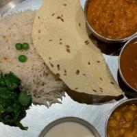Thali · Traditional Nepali combination platter served with rice, daal (lentil soup). Rayo saag (must...