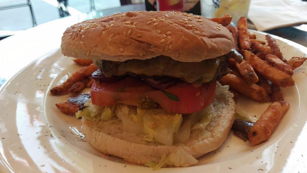Le Chateau Burger (8 Oz) · Angus burger, American cheese, lettuce, tomato, onion, French fries.