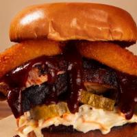 Brisket Sandwich · Slow smoked brisket topped with pickle, onion rings, coleslaw and our house bbq sauce.