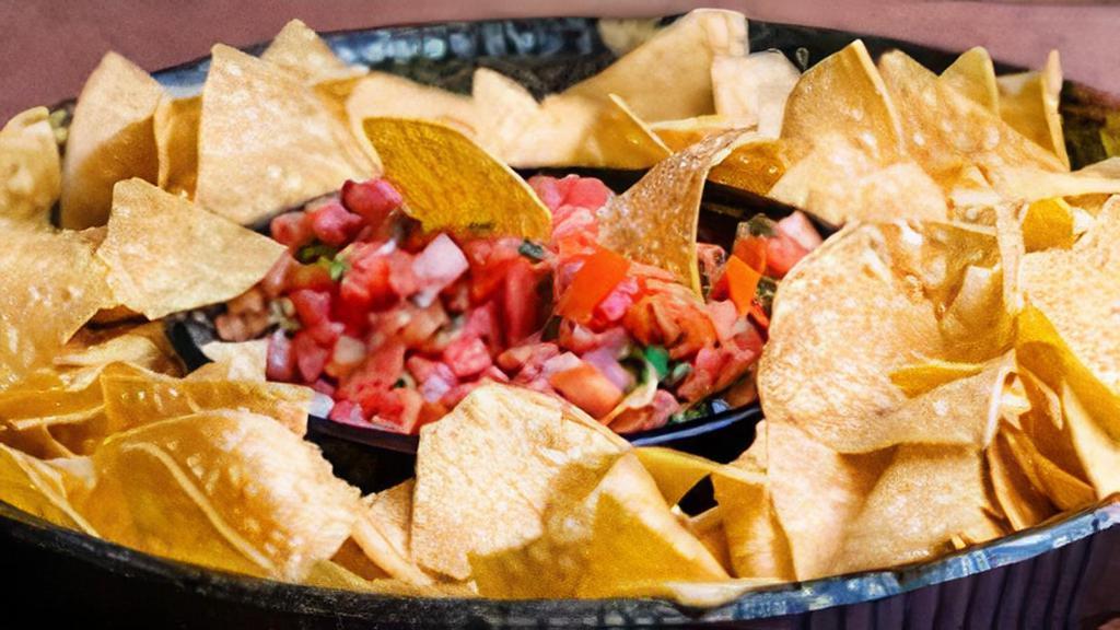 Nacho Tray & Salsa (Up To 10 Servings) · A Heaping Pile Of Corn Tortilla Chips Topped With, Queso, Cheese, Sour Cream, Salsa And One Choice Of Marinated Grilled Chicken, Steak, Pull Chicken, Ground Beef, Carnitas and/Or Vegetarian.
