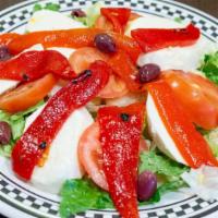 Caprese Salad · Fresh mozzarella, sliced tomato, roasted peppers and olives.