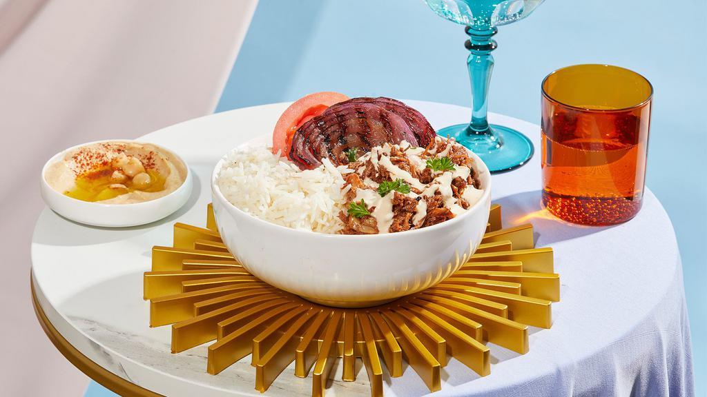Beef Shawarma Bowl · Tender beef over rice with hummus, tomatoes, grilled onions, and drizzled with your choice of sauce.