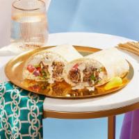 Shawarma Burrito · Your choice of shawarma with rice, lettuce, tomato, onion, and feta wrapped in a tortilla.