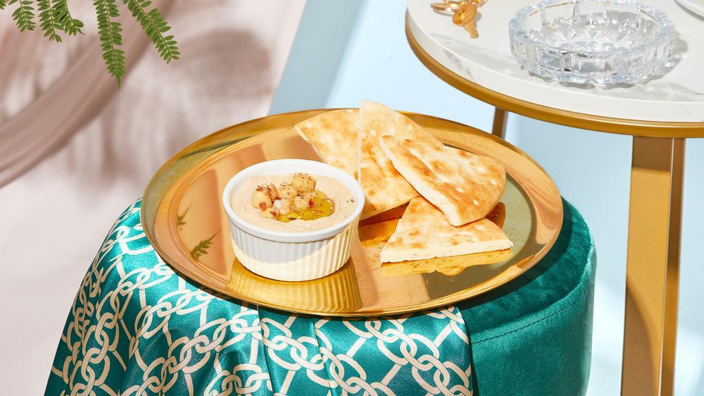 Hummus And Pita · Chickpeas, garlic, lemon, and olive oil blended into a creamy dip and served with pita.