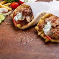 The Beef Gyro Pita · Thick and fluffy pita bread filled with thin flavorful slices of beef, lettuce, tomato, onio...