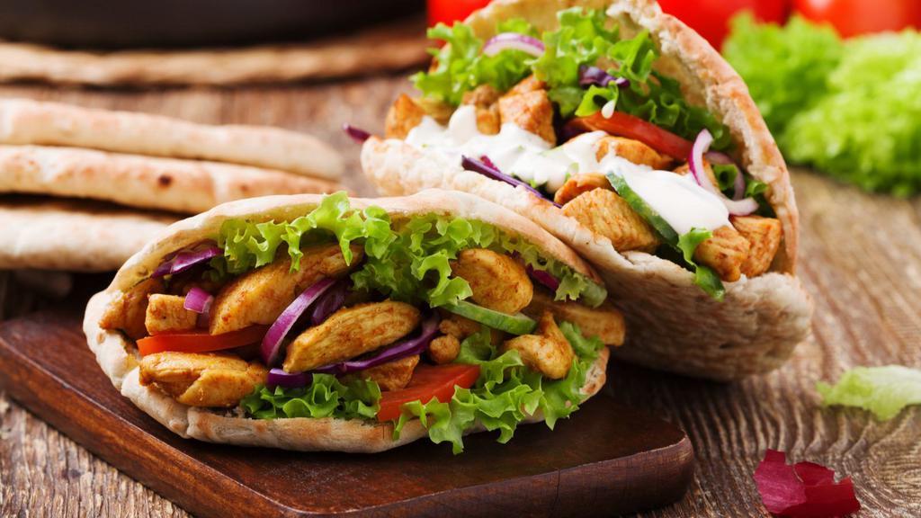 The Chicken Kebab Pita · Thick and fluffy pita bread filled with chicken kebab, lettuce, tomato, onion, and tzatziki sauce.