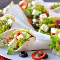 The Greek Salad Pita · Thick and fluffy pita bread filled with feta cheese, olives, lettuce, tomatoes, cucumbers, g...