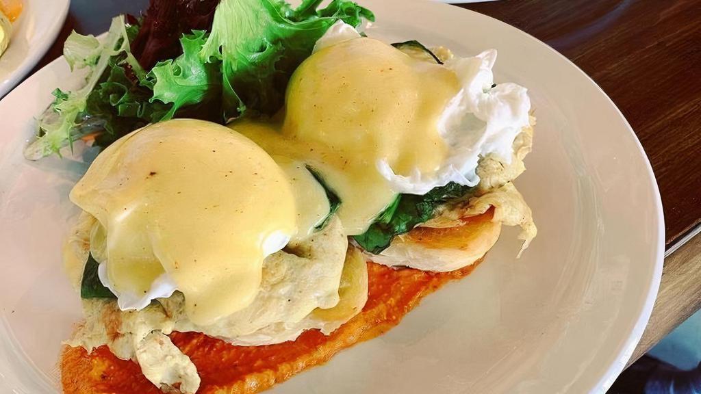 Crab Meat Benedict · crab cake, spinach, poach eggs, romesco sauce, hollandaise sauce, served on french bread, and mix greens on the side with house made Lillikoi (passion fruit) dressing.