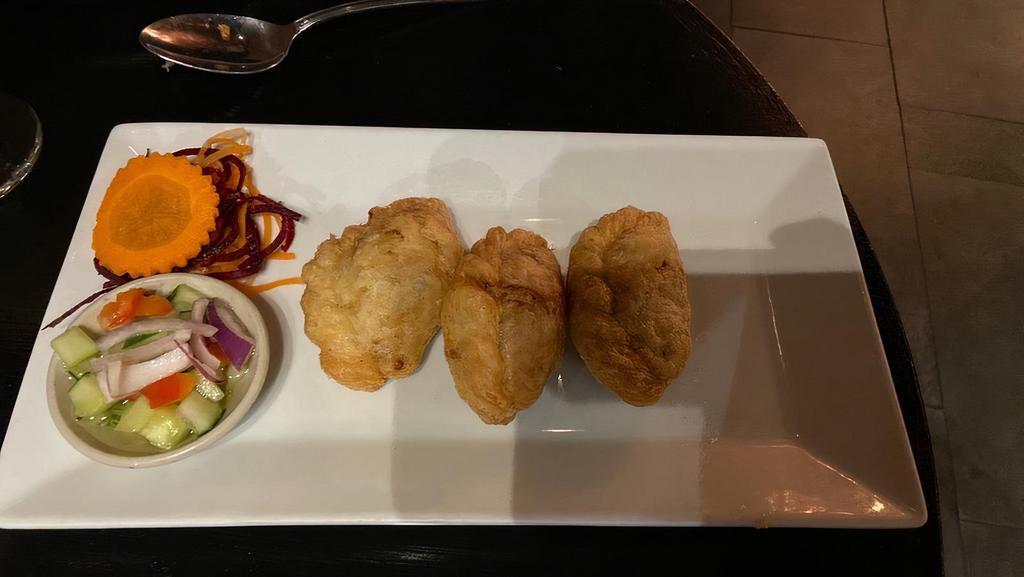 Puff Pocket · Curry chicken and potato wrapped in puff pastry with cucumber relish.