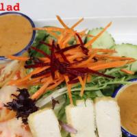 Thai Salad · Fresh green salad and peanut sauce.