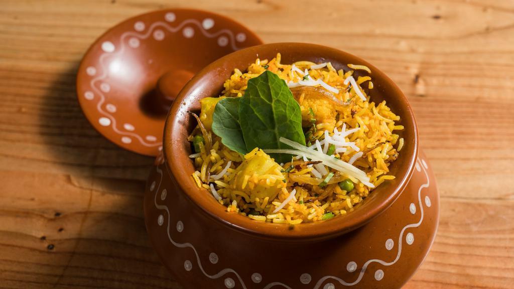 Vegetable Biryani · Hot, gluten free, vegetarian. Assorted fresh vegetables cooked with basmati rice and Indian special herbs and spices.