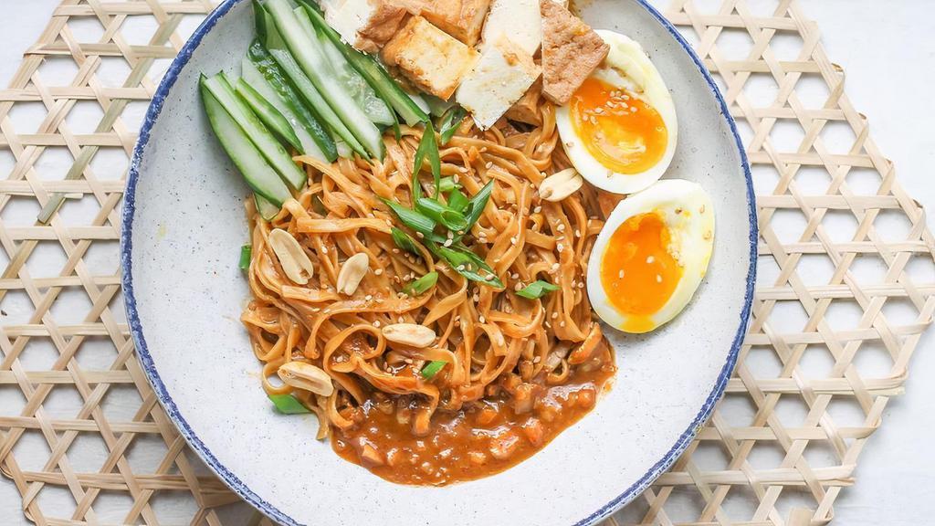 Satay Peanut Noodles · Vegetarian. Peanut and sesame sauce, wide egg noodles, soft-boiled egg, cucumbers, crispy onions. Contains: Eggs, Peanuts, Soy.