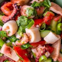 Octopus Salad · Grilled octopus, mixed green, tomatoes, onions, green bell peppers, olive oil and lemon juice.