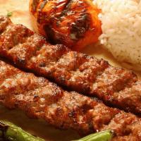 Adana Kebab · Slightly seasoned hand chopped lamb, flavored with red bell peppers, grilled on skewers and ...